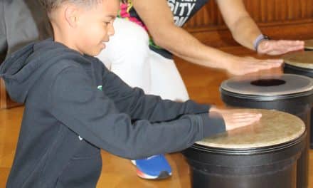 Kids bang away on Brazilian drums!